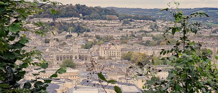 Landscape view of Bath City from a high vantage point with whole city and Bath Abbey in view.