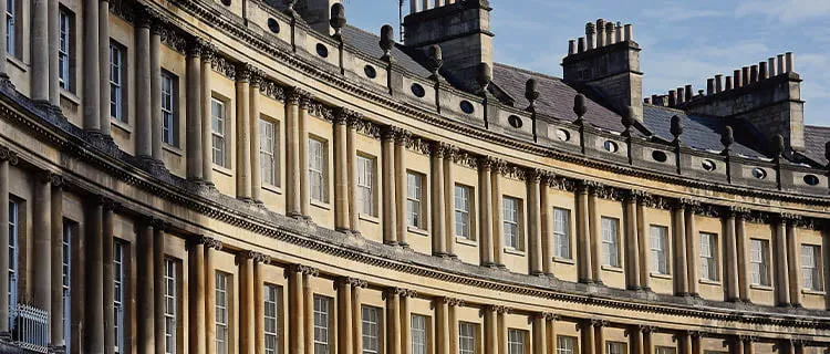 Image of Royal Crescent in Bath city centre showing top floors, windows and curvature of the houses.