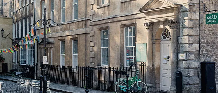 Image of a pedestrianised street with commercial buildings bunting and a bike