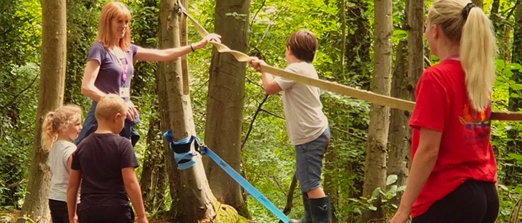 Children playing on obstacle course in the woods